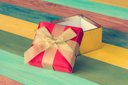 Open gift box on color wooden background.Copy-space.の写真素材