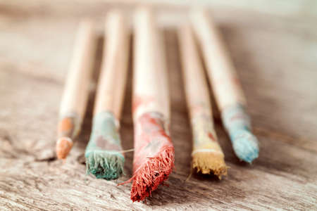 Close-up view of dirty paint brushes on wooden background, shallow DOFの写真素材
