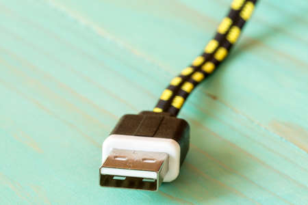 USB cable on blue wooden backgroundの写真素材