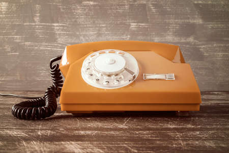Old vintage classic telephone on wooden tableの写真素材