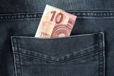 Ten Euro in a back pocket of black jeansの写真素材