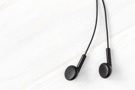 Earphones on wooden background with copy-spaceの写真素材