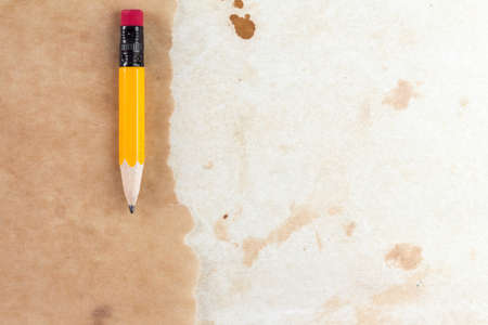 Piece of a old paper with a short pencil の写真素材