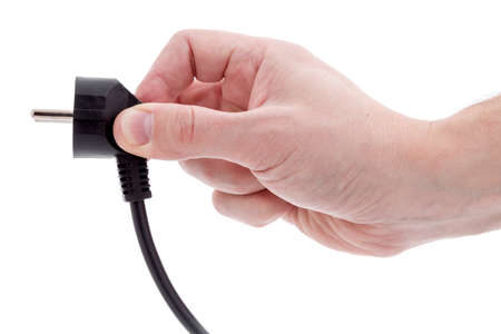 Hand holding electric plug isolated on white background