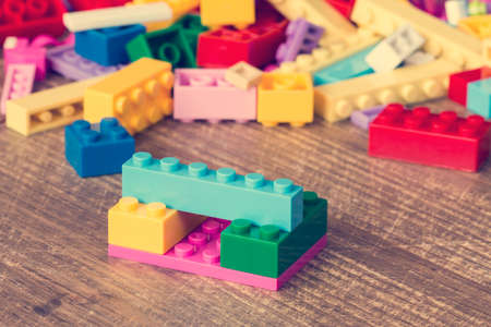 Colored toy bricks on the wooden surfaceの写真素材