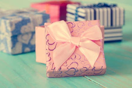 Close up of holiday gifts over wooden background