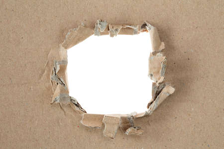Ripped hole in brown cardboard. Copy-space.の写真素材