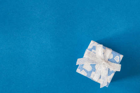 Small gift on blue background. Free space for your text.の写真素材