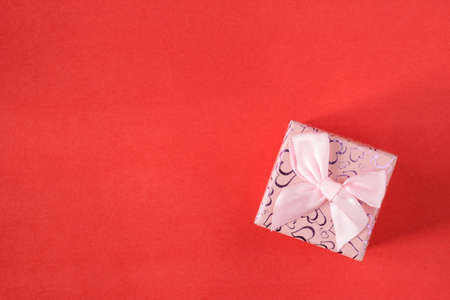 Small gift on red background. Free space for your text.