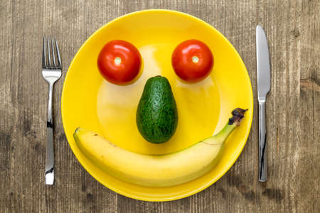 Healthy eating smiling face from vegetables and fruits on plate