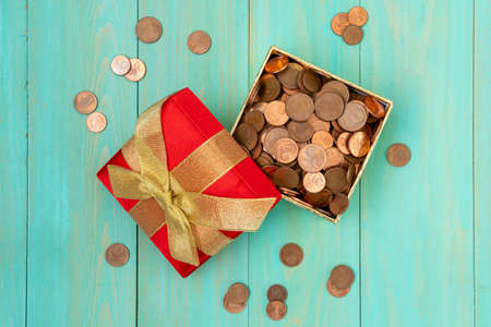 Gift box full of coins. Top view.の写真素材