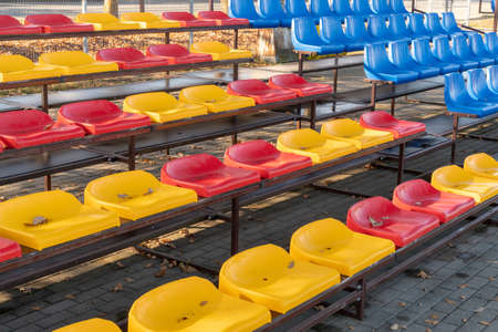 Empty plastic seats at small city stadium
