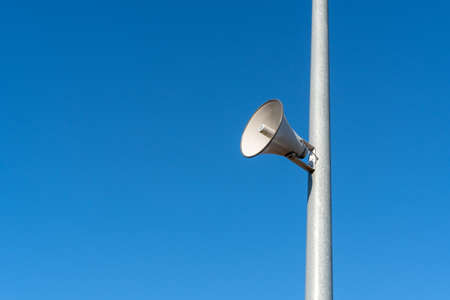 Outdoor stadium loudspeaker over blue sky backgroundの写真素材