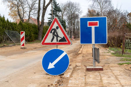 Road works sign for construction works in city street. Road under construction traffic sign.