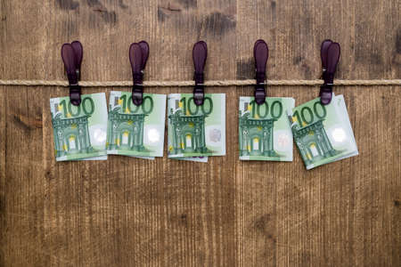 Euro banknotes hanging on a rope with clothes pins.Money laundering concept