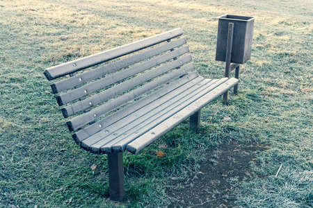Frosty frozen bench in the Park . The first frost. Autumn or winter natural background