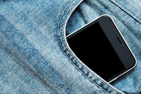Smartphone with black screen in jeans pocket