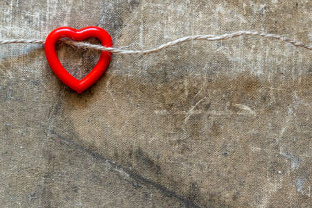 Cute red heart hanging on the string. Copy space.