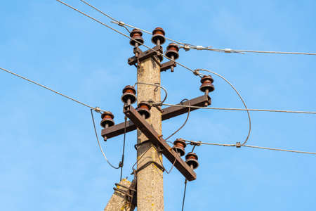 Insulators power lines against the sky backgroundの写真素材