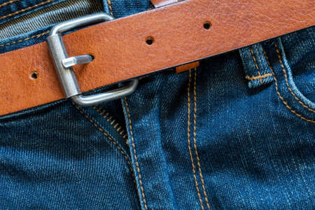 Blue jeans and brown leather belt. Close-up view.の写真素材