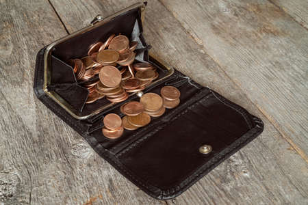 Old black wallet full of euro cents