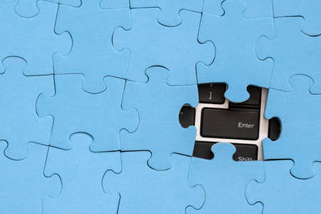 Computer Enter key under jigsaw puzzle. Computer problems solving concept