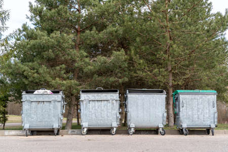 Four big  trashcans standing in the public parkの写真素材