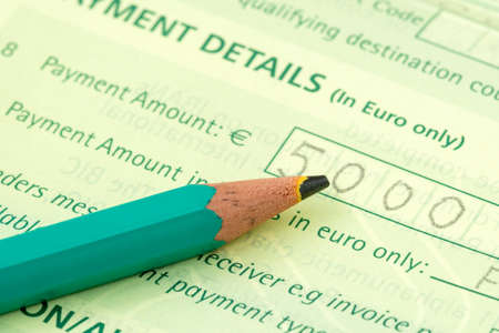 Close-up of pencil on International money transfer documentの写真素材