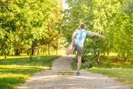 Young man does the exercises in the parkの写真素材