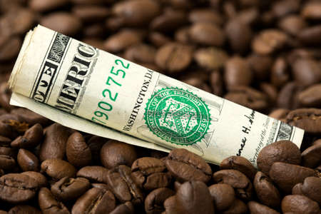 USA coffee market. Roasted coffee beans and USD currency close-up