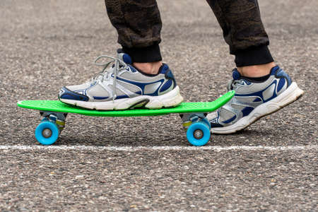 Close-up of skateboarder legs. Man ride skateboard on a city street.