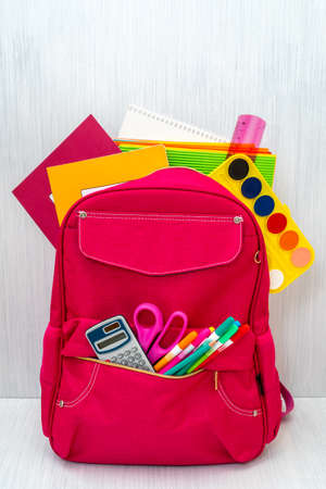 Back to school concept. Backpack with school supplies on the wooden background.の写真素材