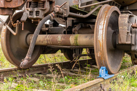 Railway brake shoe under the train wheel on the railsの写真素材