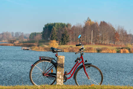 Stationary bicycle on cycle path with amazing scenic views of a lake & parkの写真素材