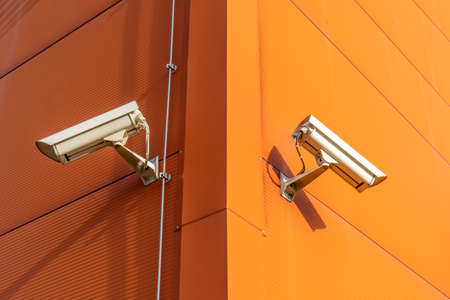 Two CCTV cameras on the cone of the modern buildingの写真素材