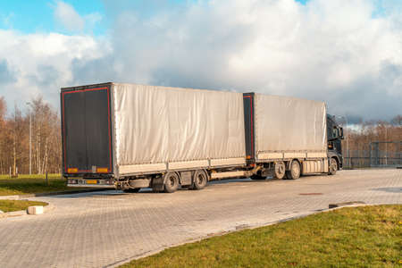 Truck with goods delivery waiting in front of the gate 