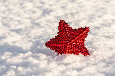 Christmas decoration red star on the fresh snowの写真素材
