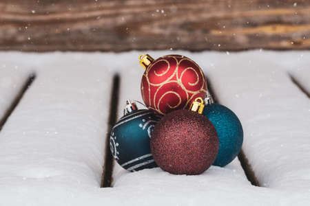 Christmas composition with christmas baubles in a snowy weatherの写真素材