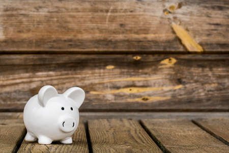Piggy bank on the old wooden background. Copy-space.の写真素材