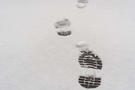 Footprints in fresh snow background, great concept for winter footwearの写真素材