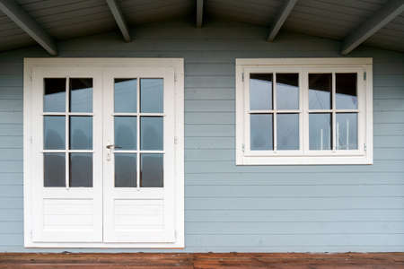 View of a wooden House Exterior and Front Door. Wooden entrance door to wooden cabin