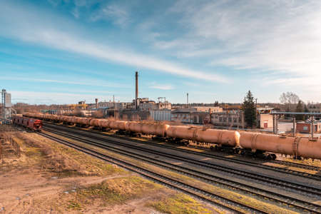 Railroad in a industrial area .Train delivering oil or gas.