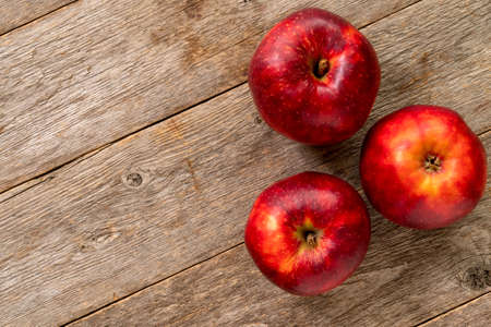 Three healthy apples on wooden background. Copy-space.の写真素材