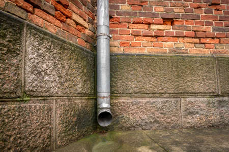 Rainwater drainage pipe on the old building wall