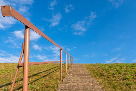 Concrete staircase against blue sky. Development motivation career growth conceptの写真素材
