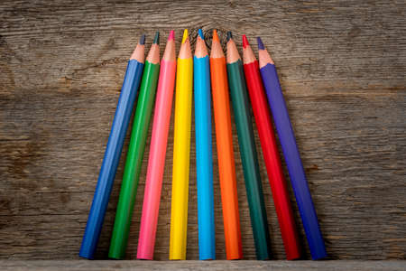Colored pencil crayons standing on the wooden shelfの写真素材