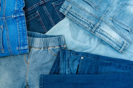 Various Shades of Blue Jeans Background. Jeans background of blue denim clothing.の写真素材