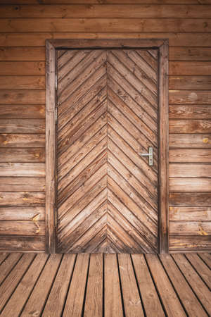 Close up of closed wooden door of ecological wooden houseの写真素材