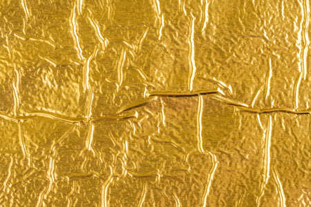 Shiny yellow leaf gold foil texture backgroundの写真素材