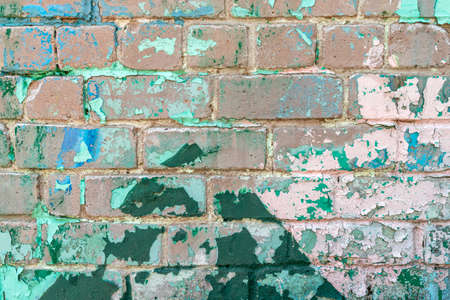 Weathered brick wall with peeling green paint. Close up view.の写真素材
